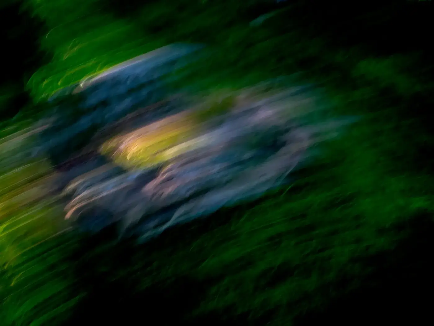 Abstract photo with diagonal streaks in green, blue and a little yellow